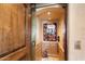 Convenient private elevator with wood paneling and a decorative mirror at 11155 E Honda Bow Rd, Scottsdale, AZ 85262