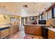 Kitchen with light wood cabinets, stainless steel appliances, and tile flooring at 11155 E Honda Bow Rd, Scottsdale, AZ 85262