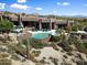 Stunning aerial view of a luxurious estate with a pool and desert landscape at 11155 E Honda Bow Rd, Scottsdale, AZ 85262