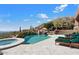 Infinity pool with a waterfall and spa, offering scenic views at 11155 E Honda Bow Rd, Scottsdale, AZ 85262