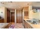 Kitchen with light wood cabinets, double sink, and tile flooring at 11155 E Honda Bow Rd, Scottsdale, AZ 85262