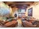 Spacious living room with comfortable seating, a fireplace, and large artwork at 11155 E Honda Bow Rd, Scottsdale, AZ 85262