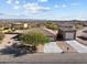 Aerial view of a house with a two-car garage and desert landscape at 265 Shawnee Dr, Wickenburg, AZ 85390