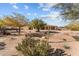 Landscaped backyard with desert plants and a large, spacious area at 265 Shawnee Dr, Wickenburg, AZ 85390