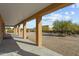 Covered patio with view of backyard and desert landscape at 265 Shawnee Dr, Wickenburg, AZ 85390