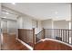 Upstairs hallway with wood railing and hardwood floors at 19428 W Colter St, Litchfield Park, AZ 85340