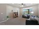 Cozy living room features a comfy couch, built-in shelving, and a view of the pool at 19428 W Colter St, Litchfield Park, AZ 85340