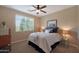 Bright bedroom with a queen bed, nightstands, and ceiling fan at 19428 W Colter St, Litchfield Park, AZ 85340