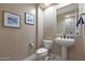 Convenient powder room with pedestal sink and toilet at 19428 W Colter St, Litchfield Park, AZ 85340