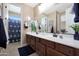 Double vanity bathroom with a shower and plenty of storage at 19428 W Colter St, Litchfield Park, AZ 85340