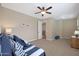 Spacious bedroom with large windows, ceiling fan, and striped bedding at 19428 W Colter St, Litchfield Park, AZ 85340