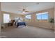 Main bedroom with large windows and mountain views, ceiling fan at 19428 W Colter St, Litchfield Park, AZ 85340