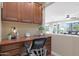 Home office with built-in cabinets and hardwood floors at 19428 W Colter St, Litchfield Park, AZ 85340