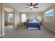 Main bedroom with large windows and mountain views, ceiling fan, and ensuite bathroom at 19428 W Colter St, Litchfield Park, AZ 85340