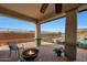 Relaxing patio with fire pit and seating overlooking the pool at 19428 W Colter St, Litchfield Park, AZ 85340