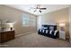 Small bedroom with daybed, ceiling fan, and wood accent table at 19428 W Colter St, Litchfield Park, AZ 85340