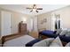 Bedroom with two twin beds, dresser, and ceiling fan at 19428 W Colter St, Litchfield Park, AZ 85340