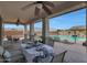 Patio dining area with seating and a view of the pool and mountains at 19428 W Colter St, Litchfield Park, AZ 85340