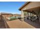 Covered patio with fire pit, seating area, and views of the pool at 19428 W Colter St, Litchfield Park, AZ 85340