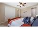 Bedroom with queen bed, dresser and ceiling fan at 19428 W Colter St, Litchfield Park, AZ 85340