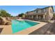 Resort-style pool with a rock waterfall and a basketball hoop nearby at 19428 W Colter St, Litchfield Park, AZ 85340