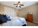 Spacious bedroom with a dresser, queen bed and ceiling fan at 19428 W Colter St, Litchfield Park, AZ 85340