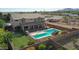 Aerial view showcasing house, pool, putting green, and basketball court at 19428 W Colter St, Litchfield Park, AZ 85340