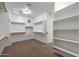 Large walk-in closet with ample shelving and hanging space at 19428 W Colter St, Litchfield Park, AZ 85340