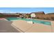 Inviting swimming pool with waterfall feature and basketball court at 19428 W Colter St, Litchfield Park, AZ 85340