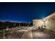 Landscaped walkway leading to the front entrance of a beautiful home at night at 18610 W Porter Dr # 93, Goodyear, AZ 85338