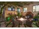 Charming courtyard featuring a fire pit, water fountain, and lush greenery at 18610 W Porter Dr # 93, Goodyear, AZ 85338