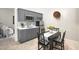 Compact kitchenette with gray cabinets and small dining area at 18610 W Porter Dr # 93, Goodyear, AZ 85338