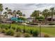 Community pool area with a lighthouse water slide and palm trees at 18610 W Porter Dr # 93, Goodyear, AZ 85338