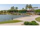 Scenic lakefront walkway with lush landscaping and palm trees at 18610 W Porter Dr # 93, Goodyear, AZ 85338