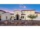 Inviting entryway to a gorgeous Spanish-style home with a black front door at 18610 W Porter Dr # 93, Goodyear, AZ 85338