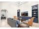 Open living area with built-in shelving, comfortable seating, and large TV at 18610 W Porter Dr # 93, Goodyear, AZ 85338