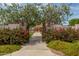 Stone pillars and gates open to a playground with blooming bougainvillea at 18610 W Porter Dr # 93, Goodyear, AZ 85338
