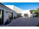 Three-car garage with paver driveway and landscaping at 18610 W Porter Dr # 93, Goodyear, AZ 85338