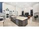 Open kitchen features a large island, stainless steel appliances, and flows into the living area at 18610 W Porter Dr # 93, Goodyear, AZ 85338