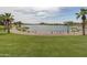 Relaxing lake view with a walking path and manicured lawn at 18610 W Porter Dr # 93, Goodyear, AZ 85338