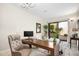 Home office with wood desk, sliding glass doors, and courtyard view at 18610 W Porter Dr # 93, Goodyear, AZ 85338