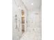 Spa-like shower with marble walls and built-in bench at 18610 W Porter Dr # 93, Goodyear, AZ 85338