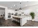 Modern kitchen with white cabinets, a large island with seating, and granite countertops at 29893 N 118Th Dr, Peoria, AZ 85383