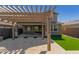 Covered patio area with pergola, string lights, and artificial turf at 15298 W Linden St, Goodyear, AZ 85338