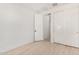 Bright bedroom with wood-look flooring and double doors leading to the hallway at 15298 W Linden St, Goodyear, AZ 85338