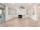 Bright living room with tile floors, fireplace, and ceiling fan at 15298 W Linden St, Goodyear, AZ 85338