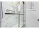 Spacious shower with marble-look tile and glass enclosure at 15298 W Linden St, Goodyear, AZ 85338