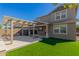 Home exterior showcasing a pergola covered patio and artificial turf at 15298 W Linden St, Goodyear, AZ 85338