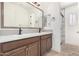 Modern bathroom with double vanity and frameless shower at 15298 W Linden St, Goodyear, AZ 85338