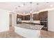Island kitchen with dark wood cabinets and granite countertops at 15298 W Linden St, Goodyear, AZ 85338